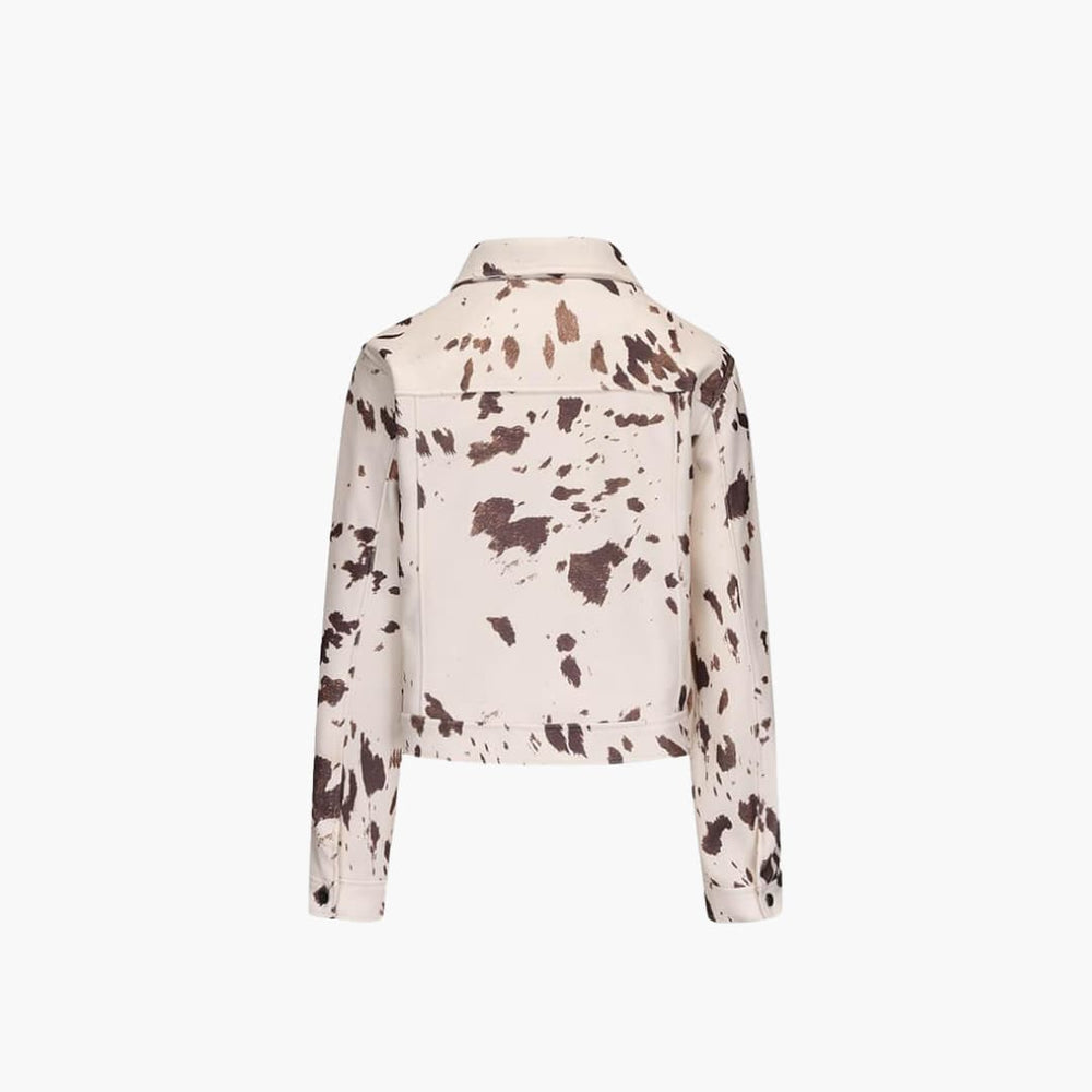 Women's cow print denim jacket, close up of cow print pattern